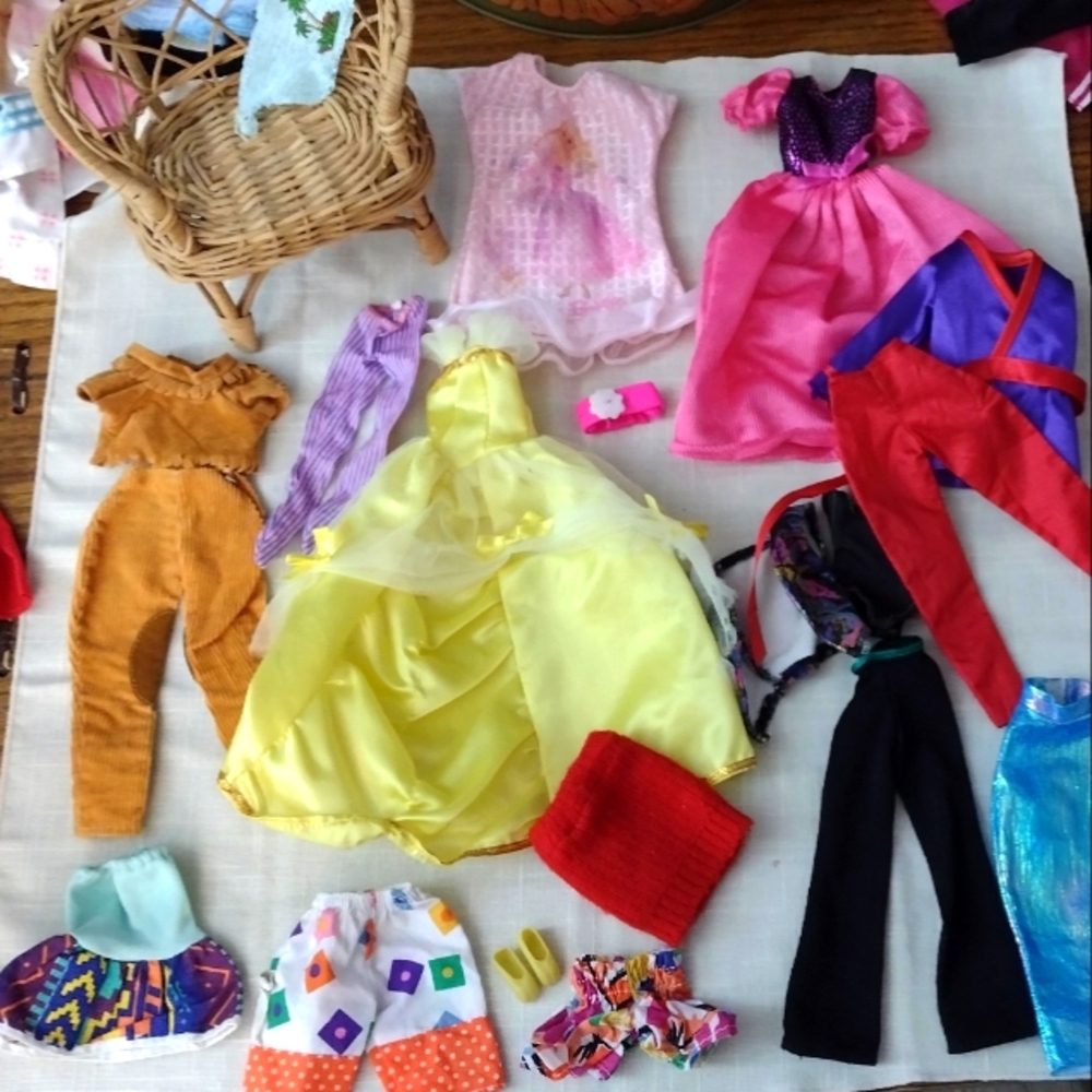Lot of barbie clothes and additional accessories.